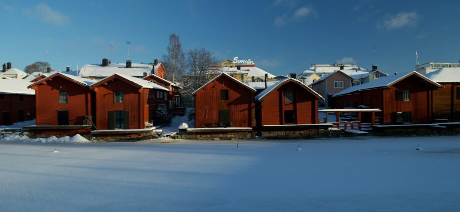 a row of red houses covered in snow